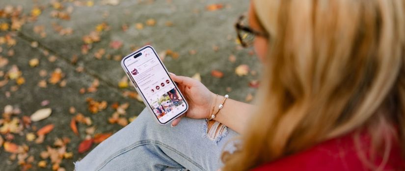 Student looking at uofsc students Instagram on their mobile phone