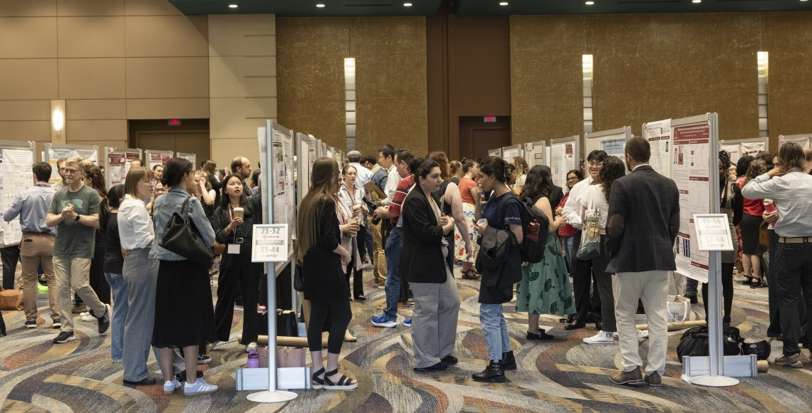 Rows of Discover USC posters are crowded with graduate student presenters, reviewers and mentors at Discover USC 2025.