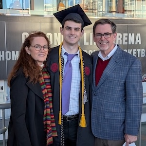  Jack Jeffrey poses with his parents during the University of South Carolina commencement ceremony in fall 2025.