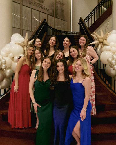 Cayleigh Marzluff with sorority sisters in formal attire.