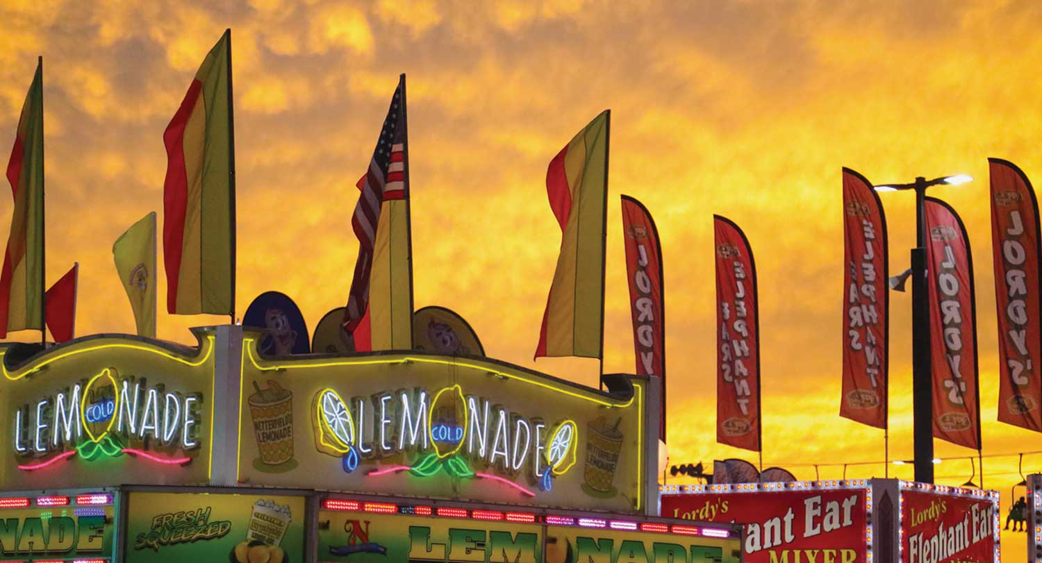 SC State Fair at sunset with a lemonade stand in the foreground