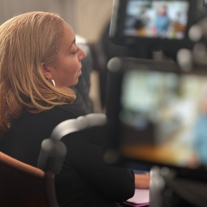 Lauren Waring Douglas interviews someone for a documentary